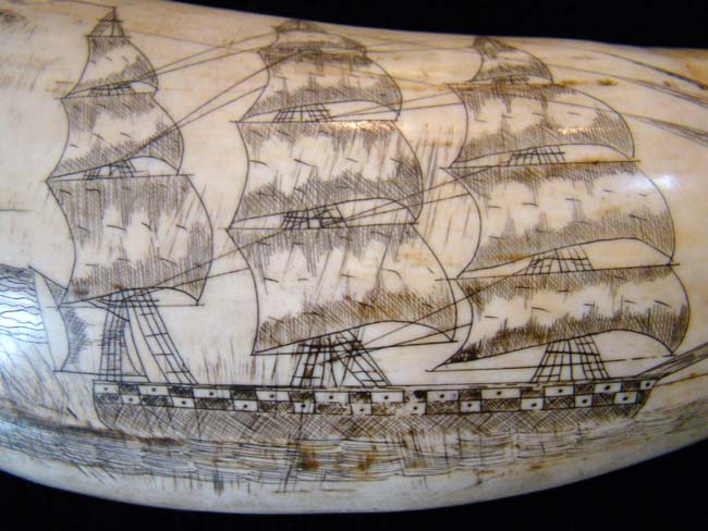 An attractive 'Liberty' themed 'sag harbor' style scrimshawed whale's tooth depicting a soldier flanked by a pair of cannons with four American flags in the background — image 3